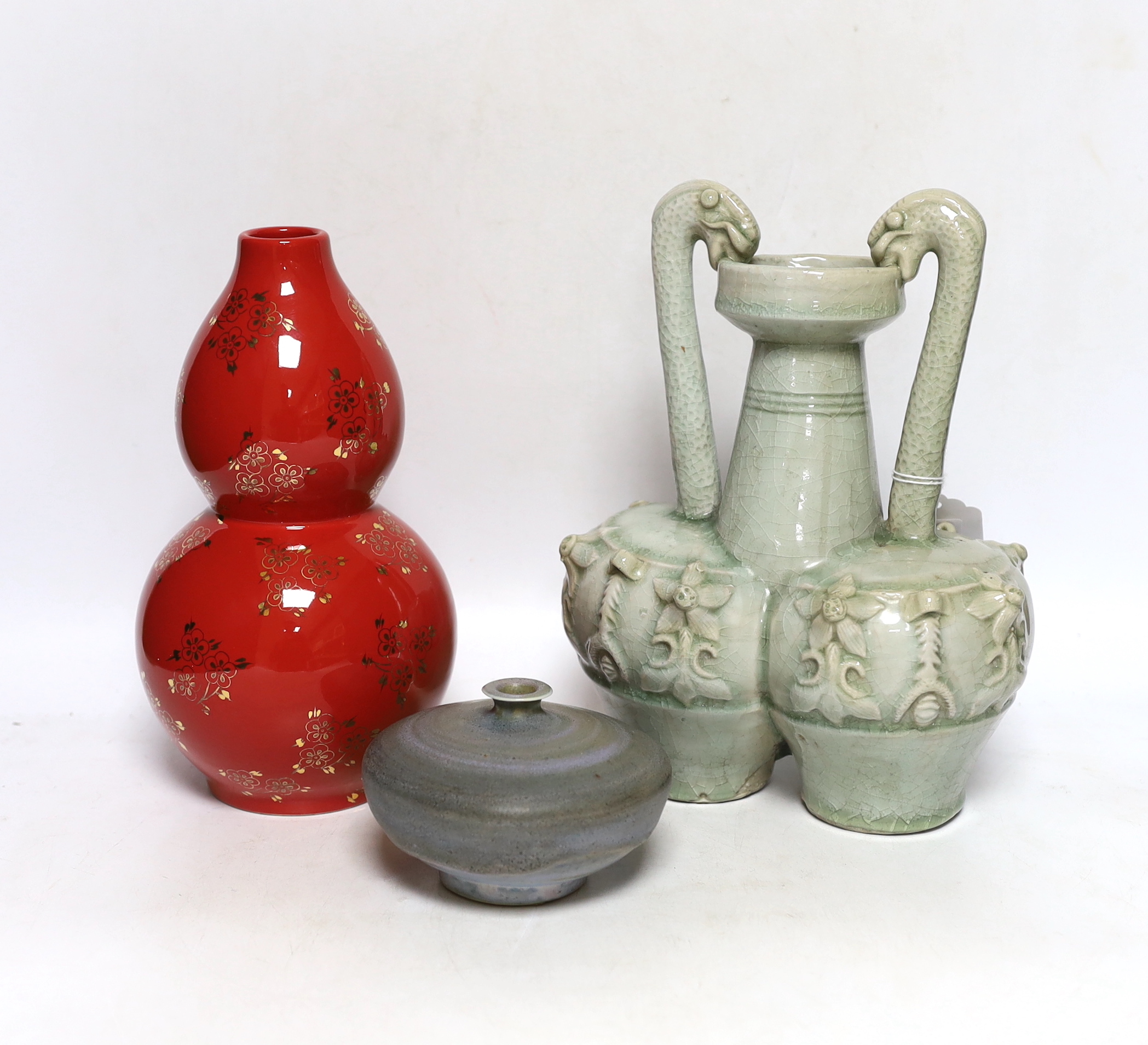 A Chinese red ground vase, Chinese celadon conjoined dragon handled vase and a studio pottery vase, 25cm